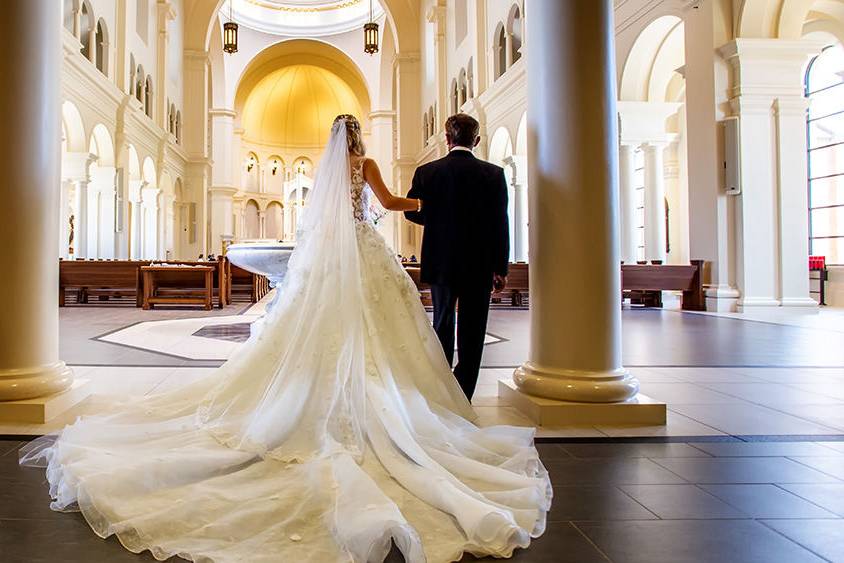 Bride and dad walk down the aisle at the Holy Name of Jesus Cathedral in Raleigh, NC