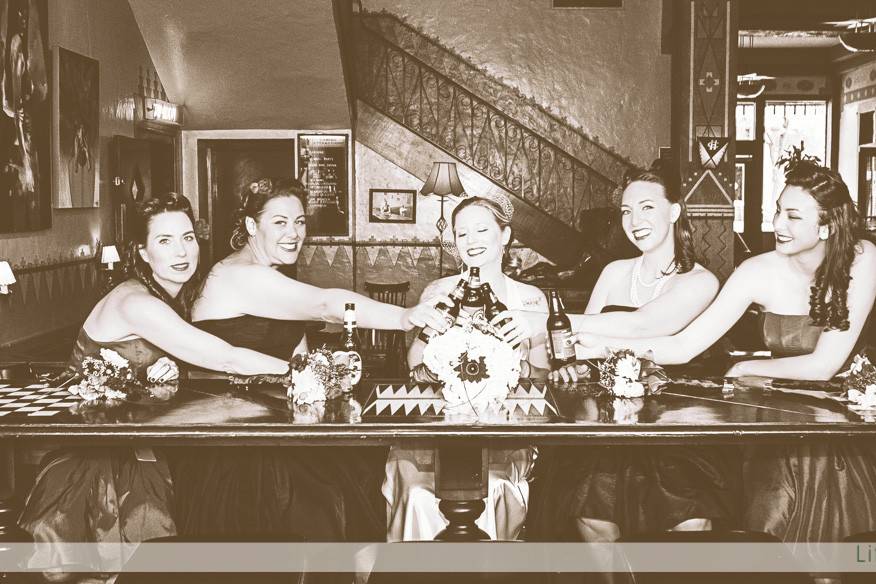 An early 40's themed wedding at the Hotel Congress in Tucson, AZ.  The bride and her court take a moment for a quick refreshment before the ceremony.