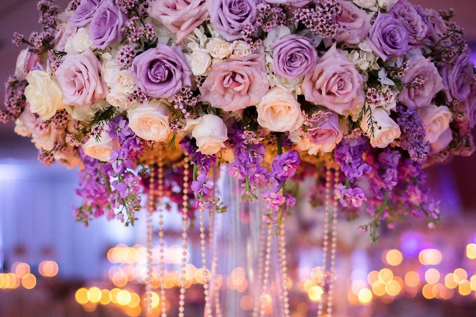 Exquisite tall centerpiece, full of blush and variation of purple color roses and flowers