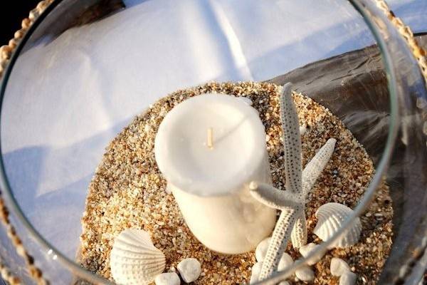 Candle centerpiece with starfish and shells
