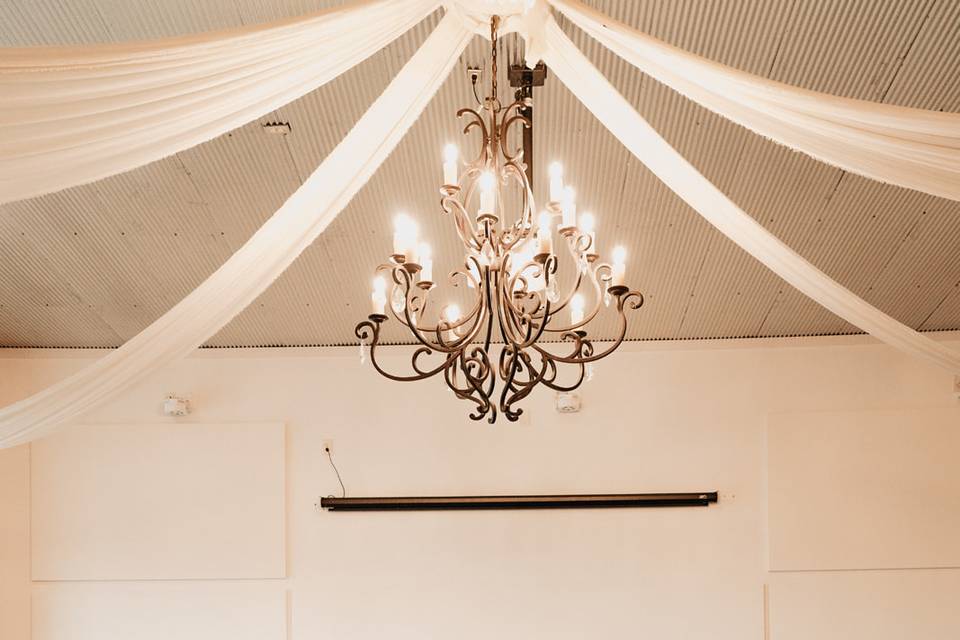 Iron-wrought chandeliers and drapery