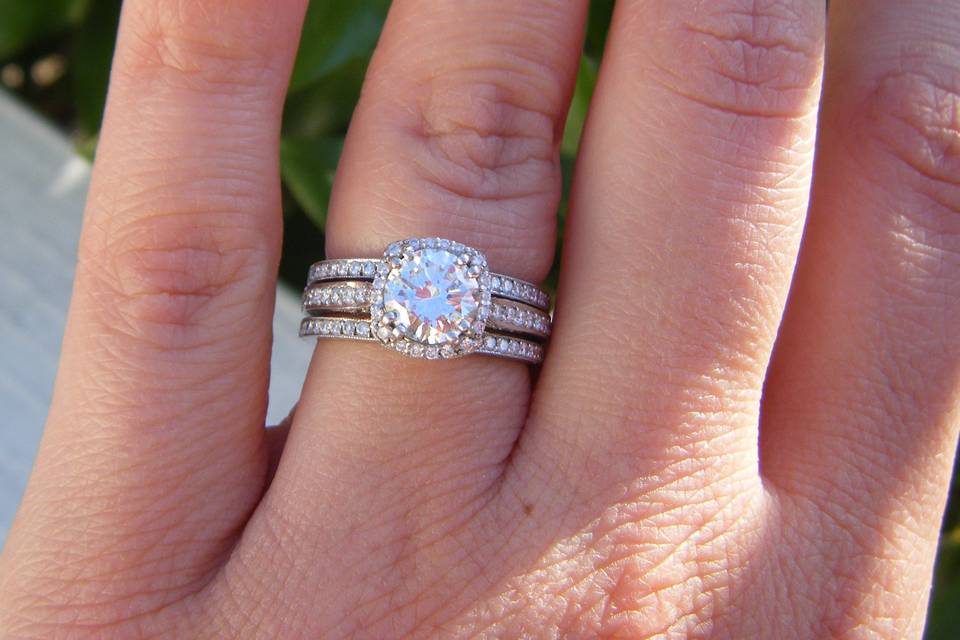 Elaine's cushion halo engagement ring with two matching bands (designer: Tacori).