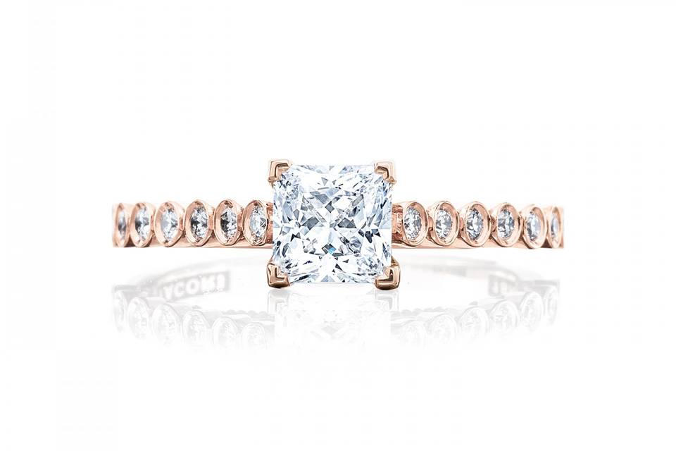 Unique Tacori engagement ring with bezel set diamond band and princess cut center diamond.