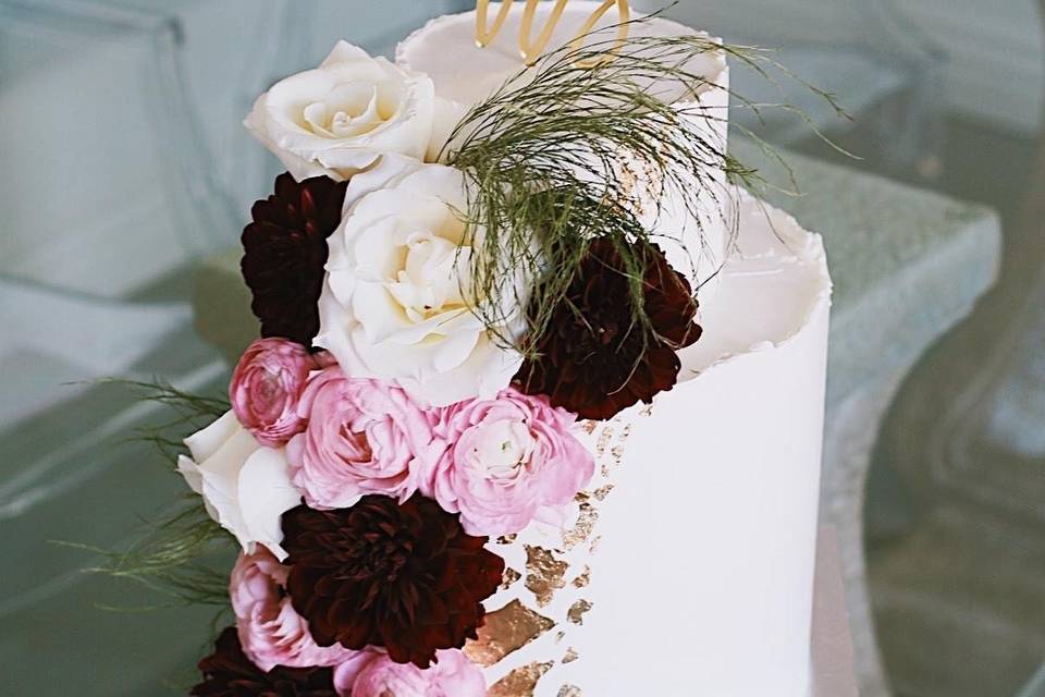 White cake with flowers and cake topper