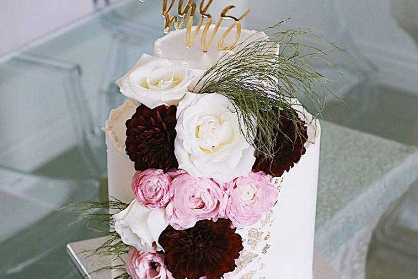 Cake with white, pink, and red flowers