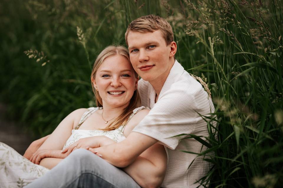 Engaged couple in tall grass