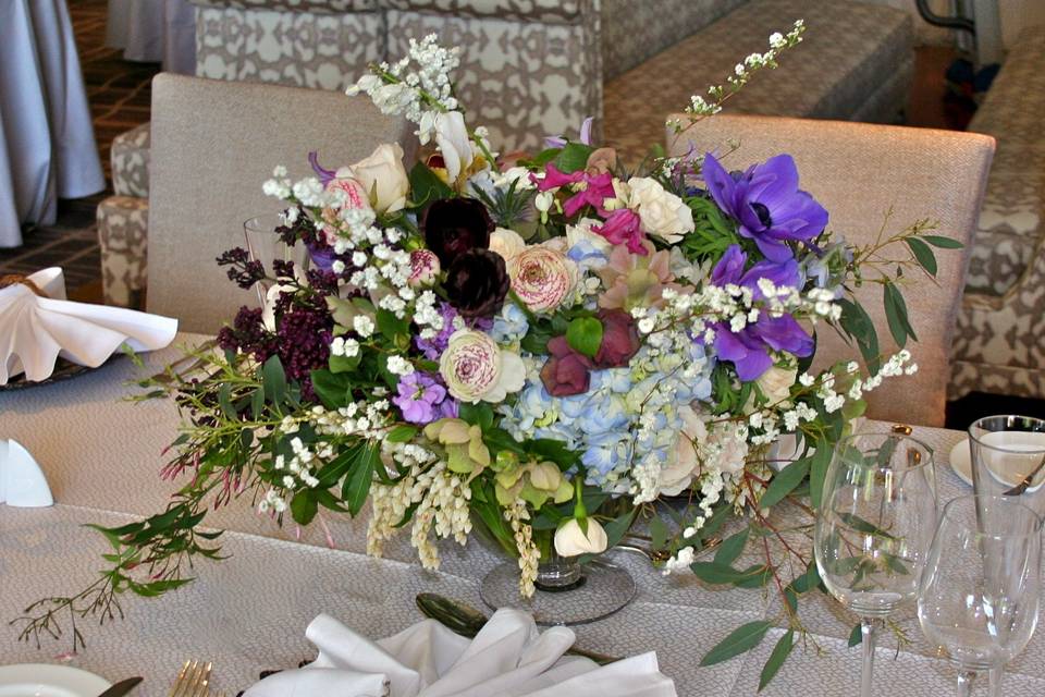 A wedding at the Four Seasons with centerpieces wild and luxurious by White Magnolia Designs.