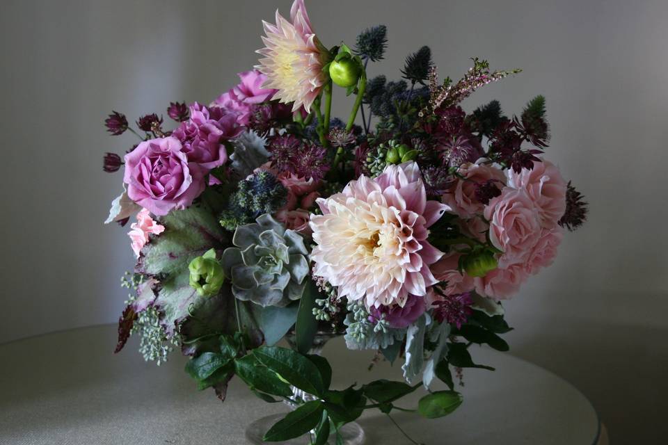 Succulents and Dahlias and spray roses and more combine to make this loose and lovely arrangement by White Magnolia Designs.