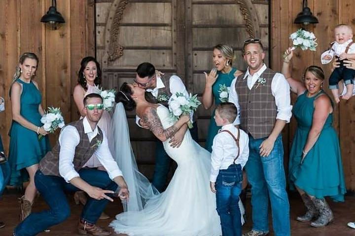 Bride and groom with their wedding party- celebrating