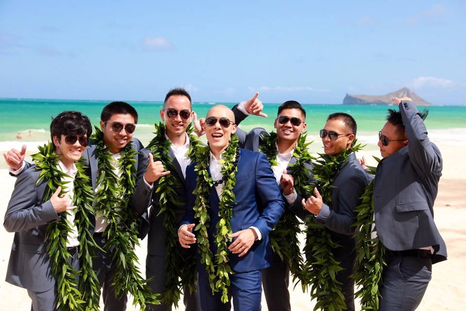 Groomsmen bonding by the ocean