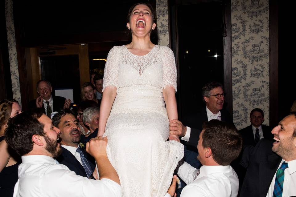 Bride carried on chair