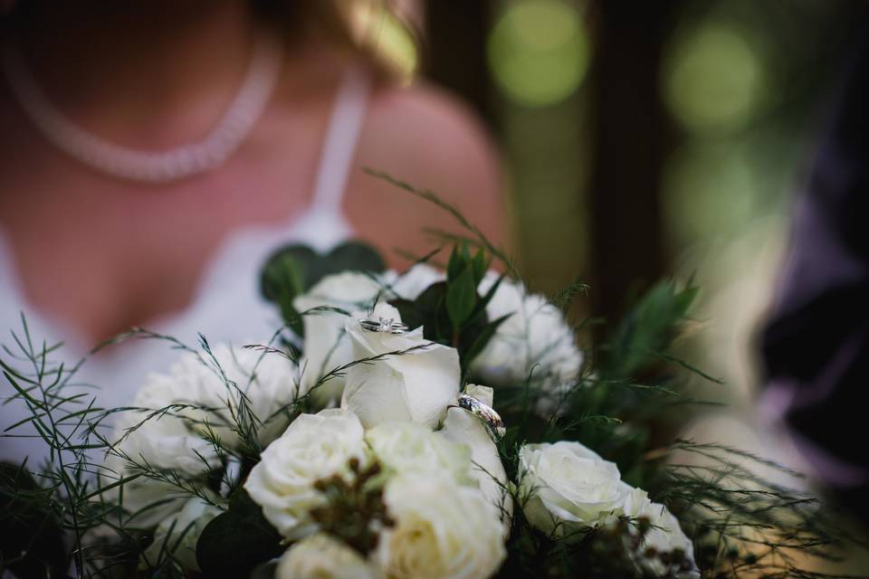 The rings hiding in her bouquet.