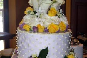 This is a 3 tiered cake with 3 seperate flavors.  The top tier is Pina Colata, middle tier, Strawberry, bottom tier was Lemon pound.  Decorated with 3 shades of Lavender and roses.