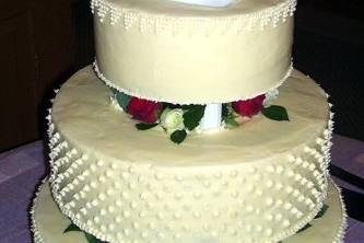 Simple cake with cream cheese icing over a white cake and red velvet cake