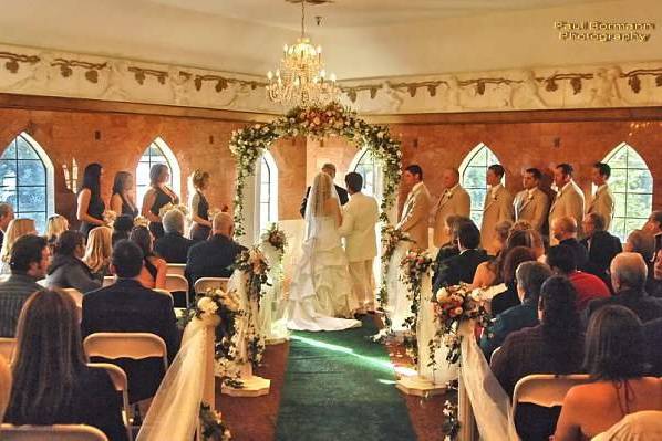 A ceremony taking place in our Huntress Ballroom.  Most of our brides prefer to be married outside in the garden.  Huntress is a great plan 