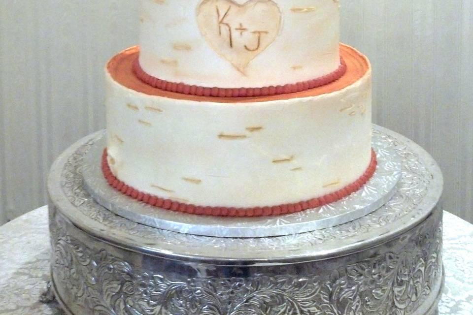 Beach wedding cake with figurines on top