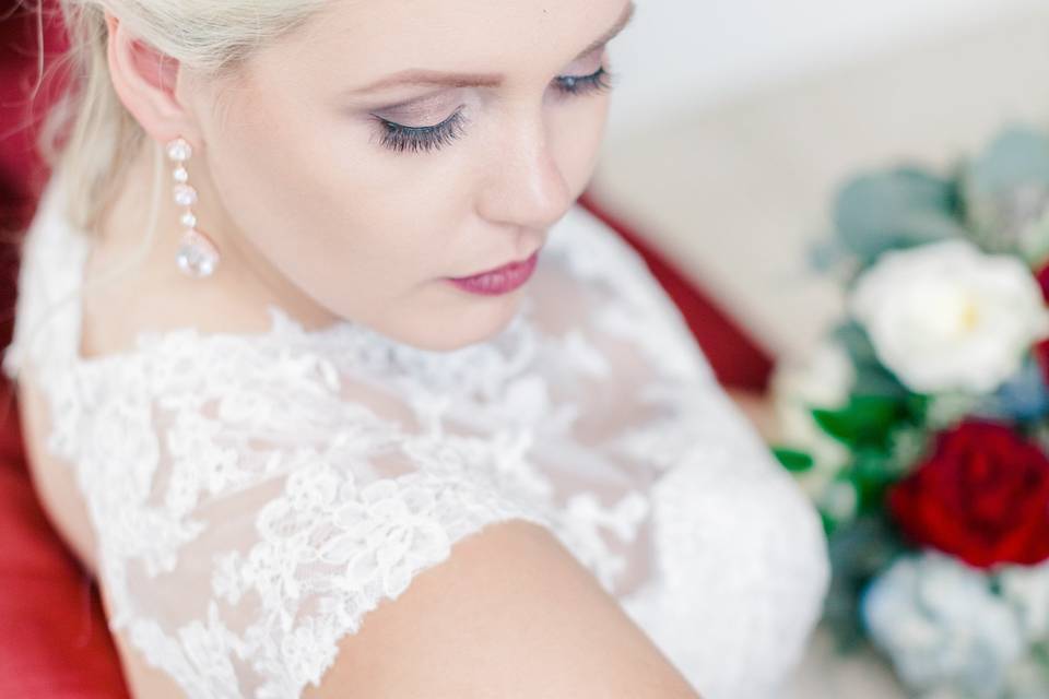 Bride sitting on red couch