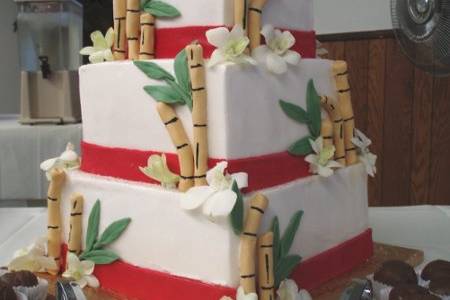 Buttercream cake with fondant bamboo and ribbon.