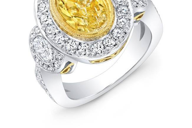 LAD-8151
This vintage-style 18KT two-tone (white & yellow gold) engagement ring features a halo design of 1.78CTS of pave-set round diamonds surrounding 1.03CT side oval stones and a 2.01CT yellow oval diamond center stone.
Call 213.626.6012 or chat with us at www.goldempirejewelry.com to get the best deal for this beautiful piece!