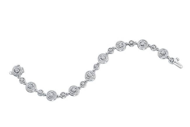 BRC-5005
This 14kt white gold vintage-style bracelet features 0.87pts of 126 small diamonds, 0.52pts of 9 medium diamonds and 1.34cts of 9 large diamonds, all of which are pave-set with a milgrain finish along the edges.
Call 213.626.6012 or chat with us at www.goldempirejewelry.com to get the best deal for this beautiful piece!