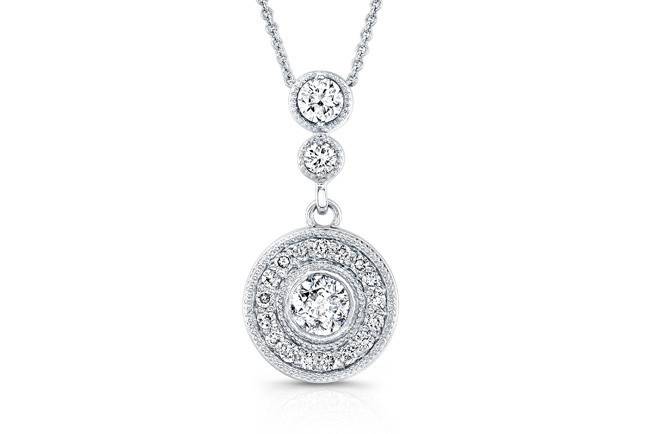 PND-6007 (http://www.goldempirejewelry.com/fashion/pendants/pnd-6007.html)
This vintage-style 14kt white gold pendant features 3 bezel-set round diamonds that weigh 0.62 points and a halo design with 0.17 points of 17 full-cut round brilliant diamonds that are pave-set with a milgrain finish along the edges. It may also feature the center stone of your choice!