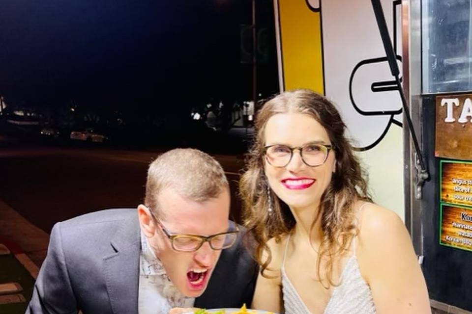 Happy couple digging into taco