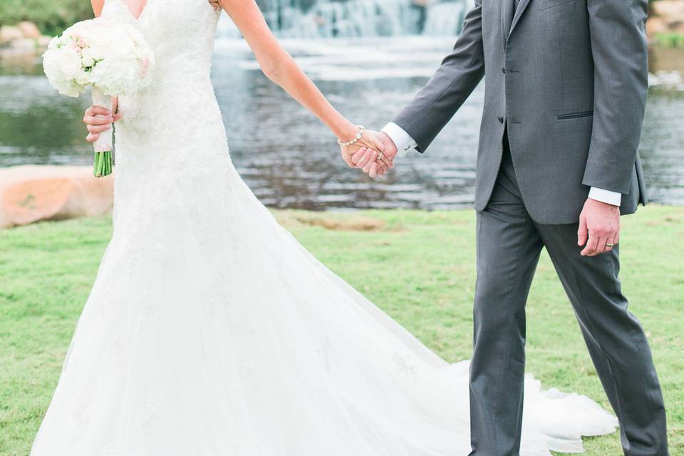 Bride and groom in front of waterfall