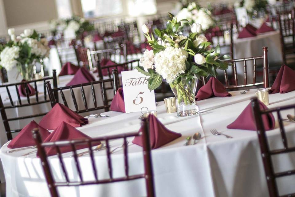 Maroon and white round table setup