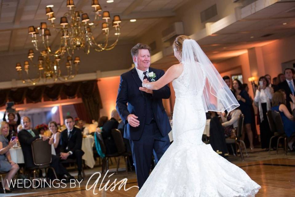 The bride and father dancing