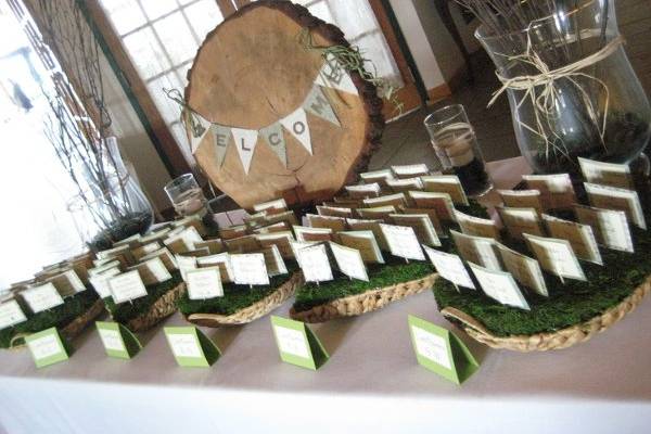 Escort card table featuring a tree round with handmade 