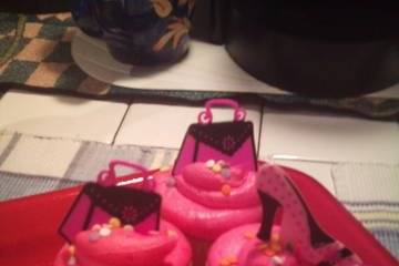 Vanilla Nut cupcakes with Whipped Cream Icing topped with Diva shoes or purse toppers.