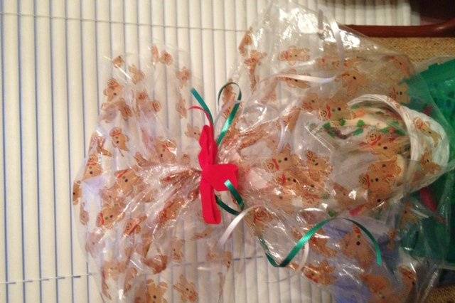 Christmas Cream Cheese Cookie Basket. Each cookie is placed in an individual holiday bag, then all the cookies are placed in a basket.  The basket is then placed in a Christmas Basket Bag and decorated with ribbon and a bow.