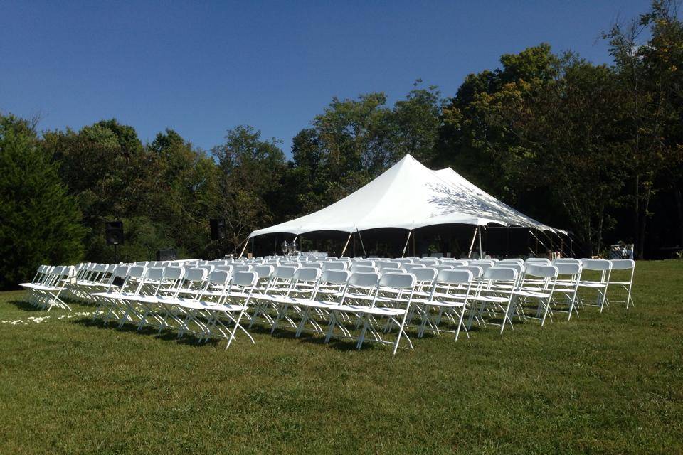 Tent and white folding chairs