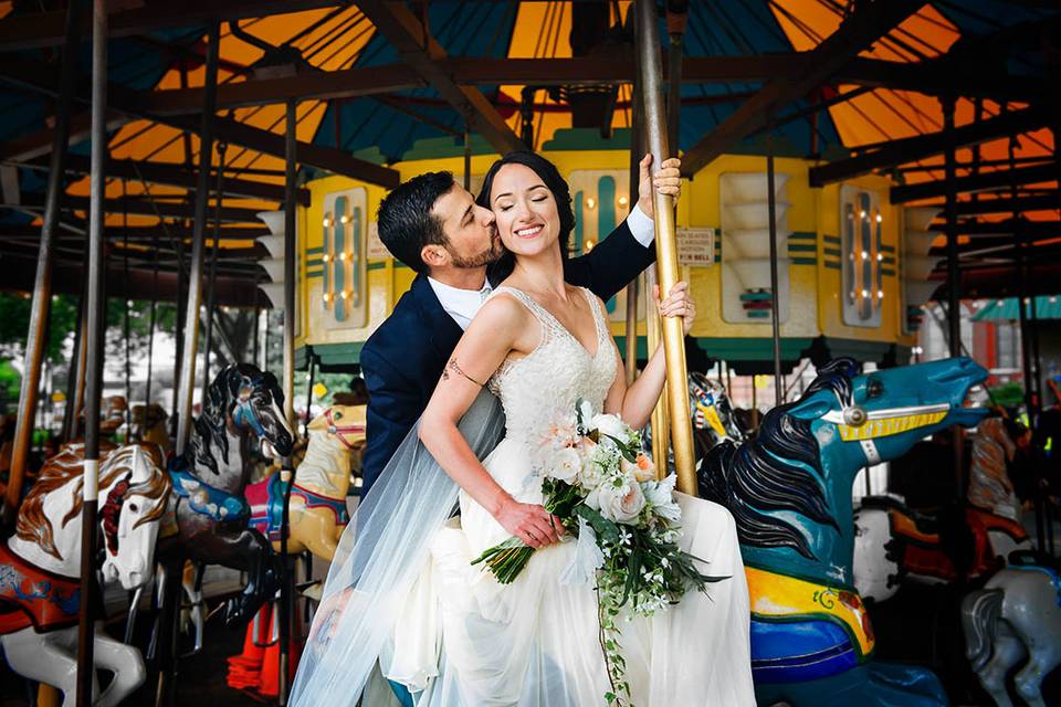 Bride and groom on carousel