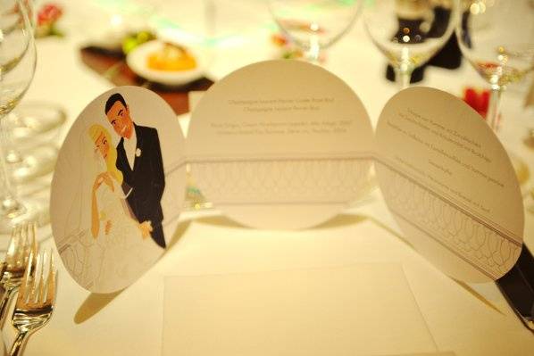 wedding stationery with bespoke illustration, showing the couple in a stylized similarity. Here shown: wedding menu, and the bride in her actual wedding gown.