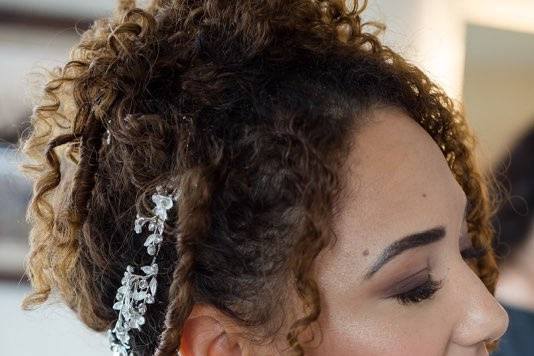 Bride putting on earrings
