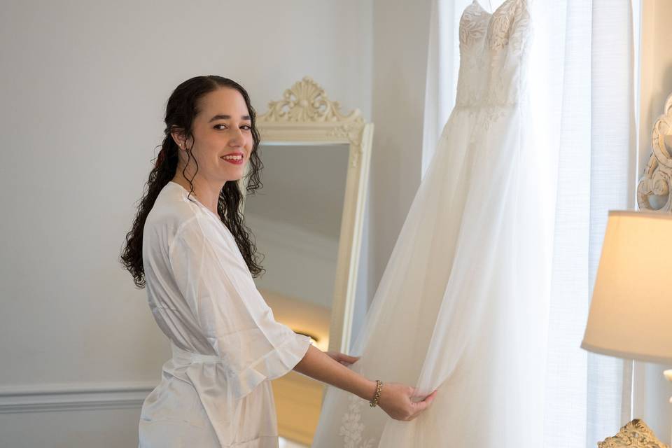 Bride admiring wedding dress
