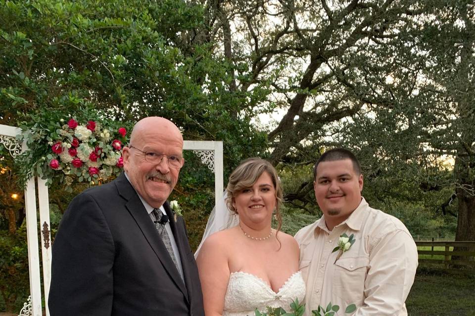 Newlyweds with their officiant