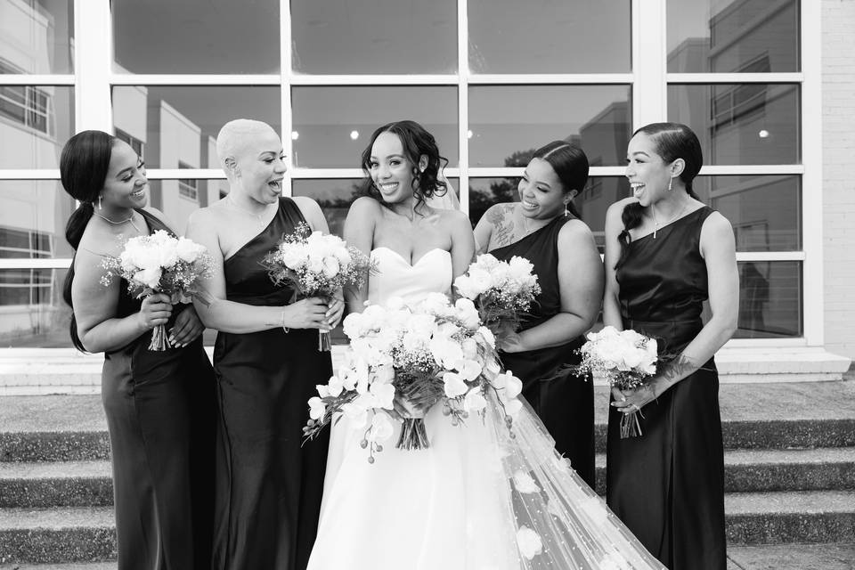 Laughs with her bridesmaids