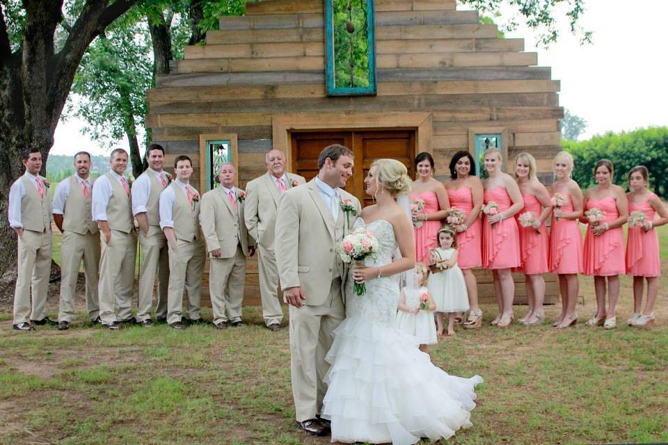 Couple with bridesmaids, flower girl and groomsmen