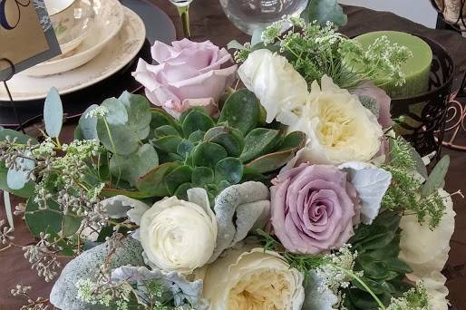 Garden style bouquet of lavender roses, patience garden roses, succulents, dusty miller, seeded eucalyptus, and ranunculus