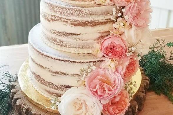 Small buttercream rustic cake with silk sunflowers, and assorted cupcakes with silk flowers