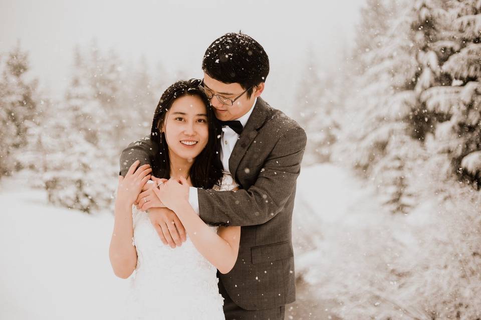 Newlyweds with umbrellas