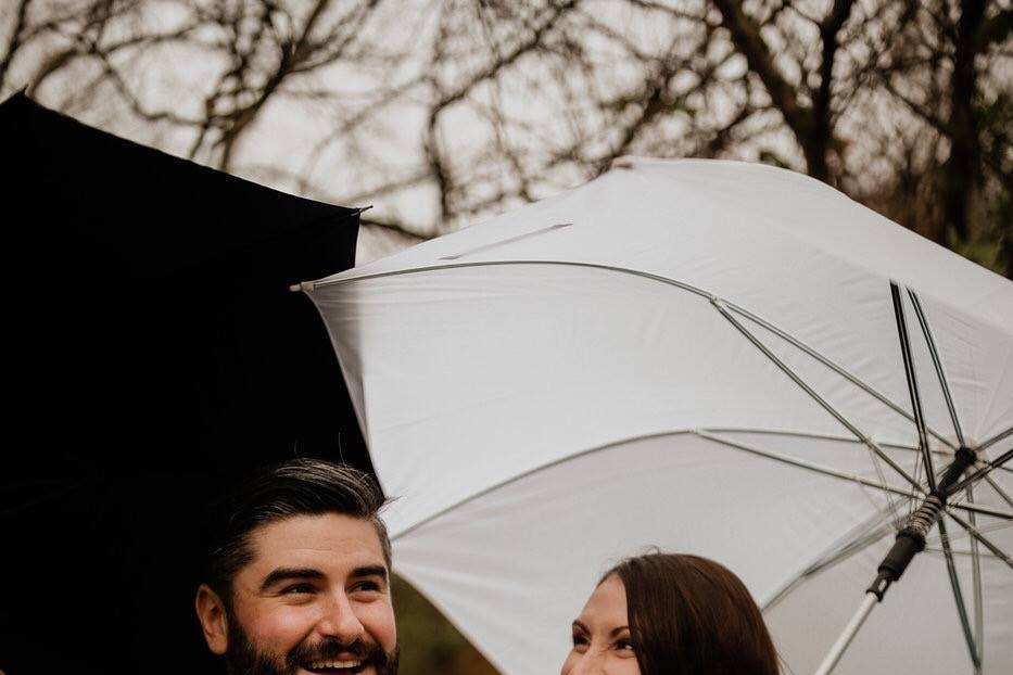 Newlyweds with umbrellas