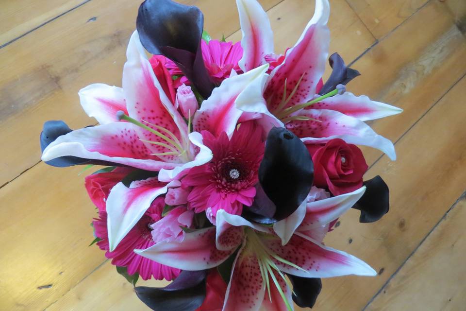 Feminine bouquet of stargazer lilies, plum calla lilies, pink roses and gerbera daisies and added bling. LOVED this!