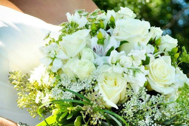 Classy white, ivory and natural green bouquet.. ..escimo roses, white stock, queen anne's lace, bear grass, variegated pitt and seeded euc made up this stunning bouquet.