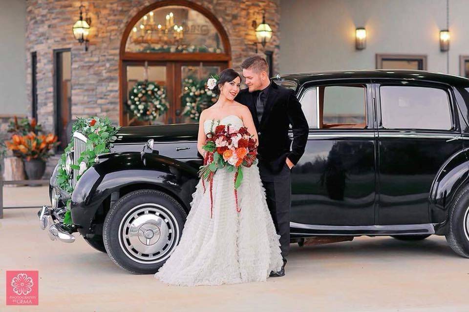 Couple with the bridal car