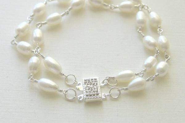 Two strands of creamy pearls
make a fabulous accessory.
Materials:  Freshwater pearls,
sterling sliver
Size:  7