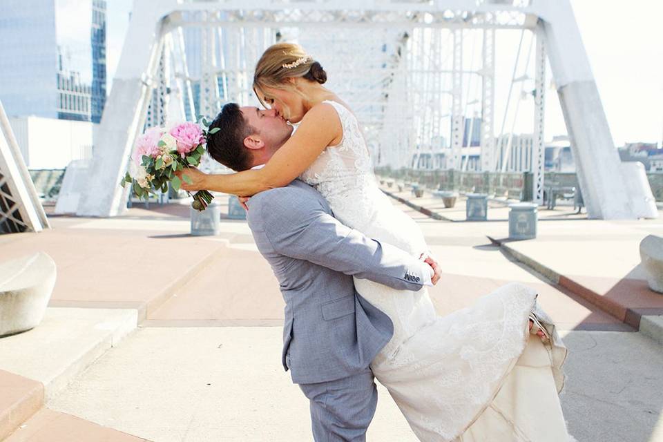 Couple kissing on a bridge