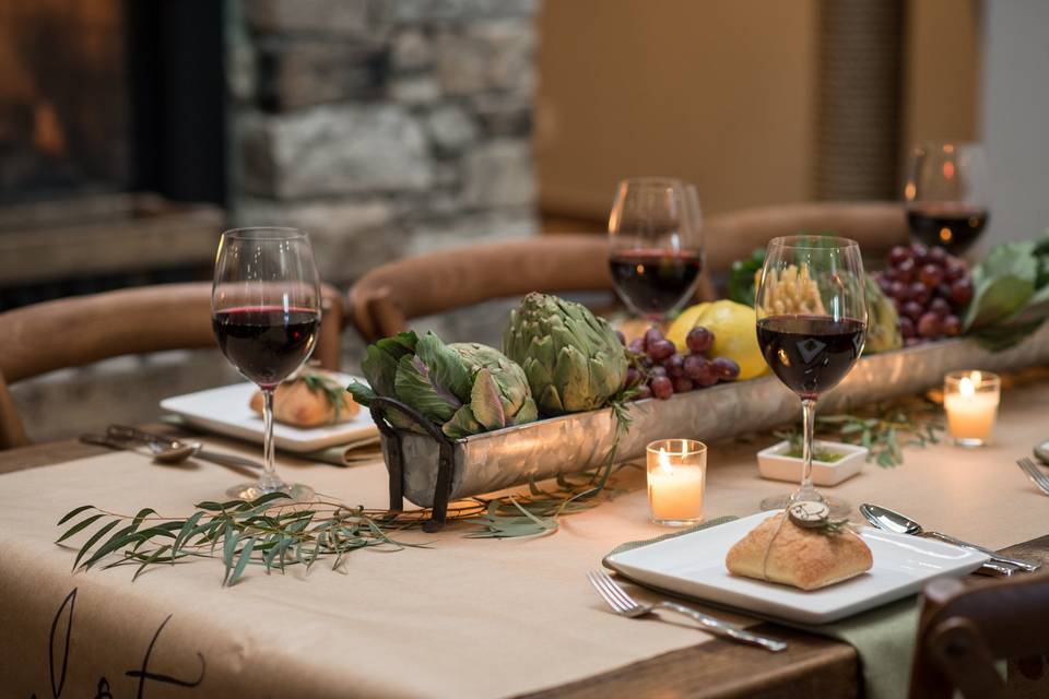 Dining table setup with fruits and vegetable on the center